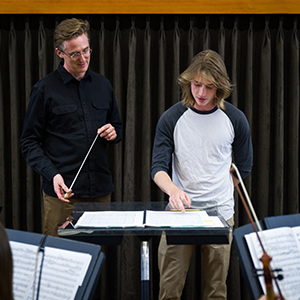 Instructor and student looking at a music score
