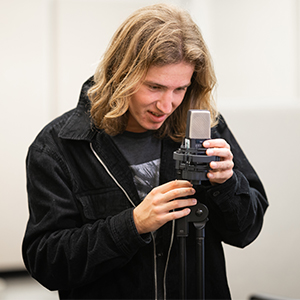 Student adjusting a microphone